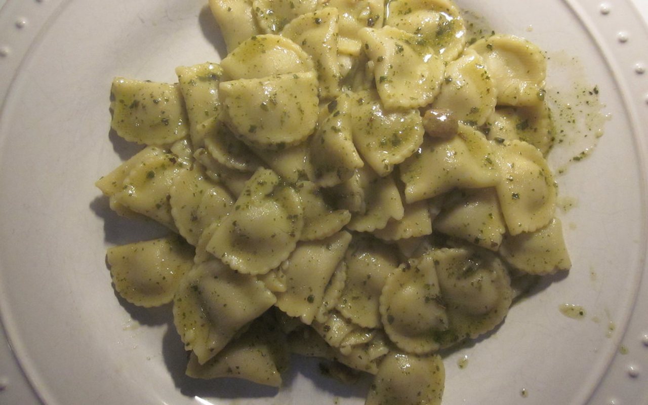 Creamy pesto pasta topped with basil and pine nuts