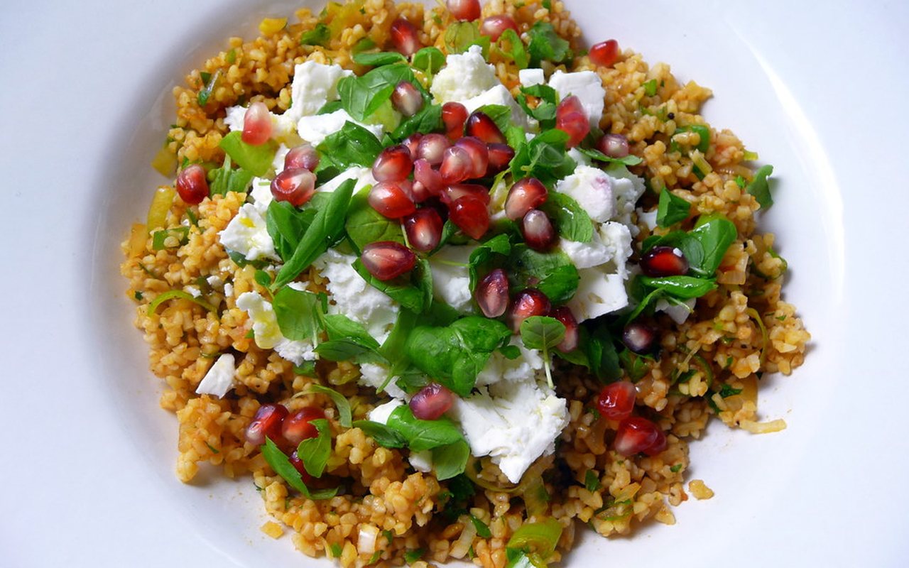 Reddish bulgur salad with scallions, parsley, and mint on a serving plate