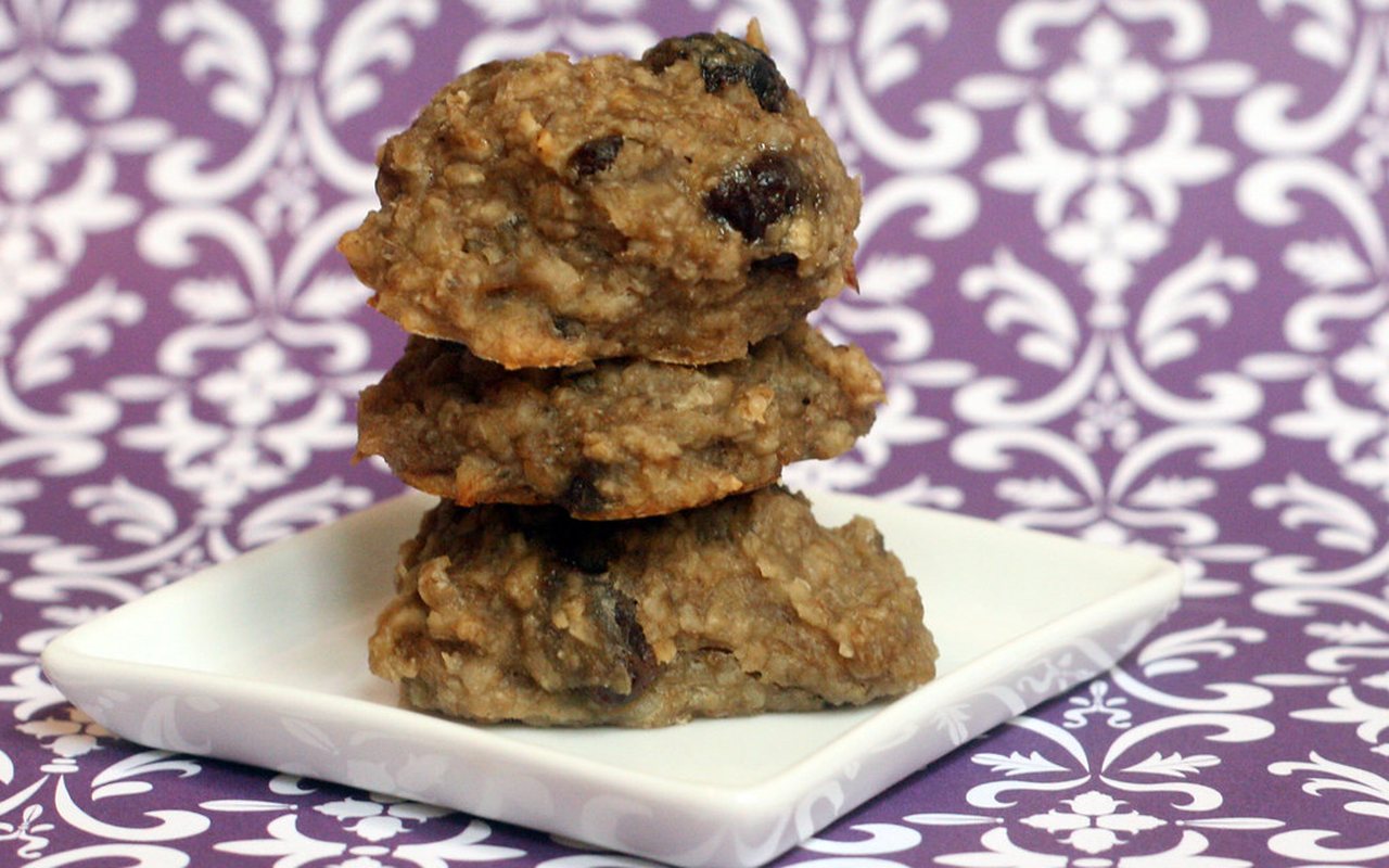 Nine rustic banana-oat cookies with raisins and chocolate pieces