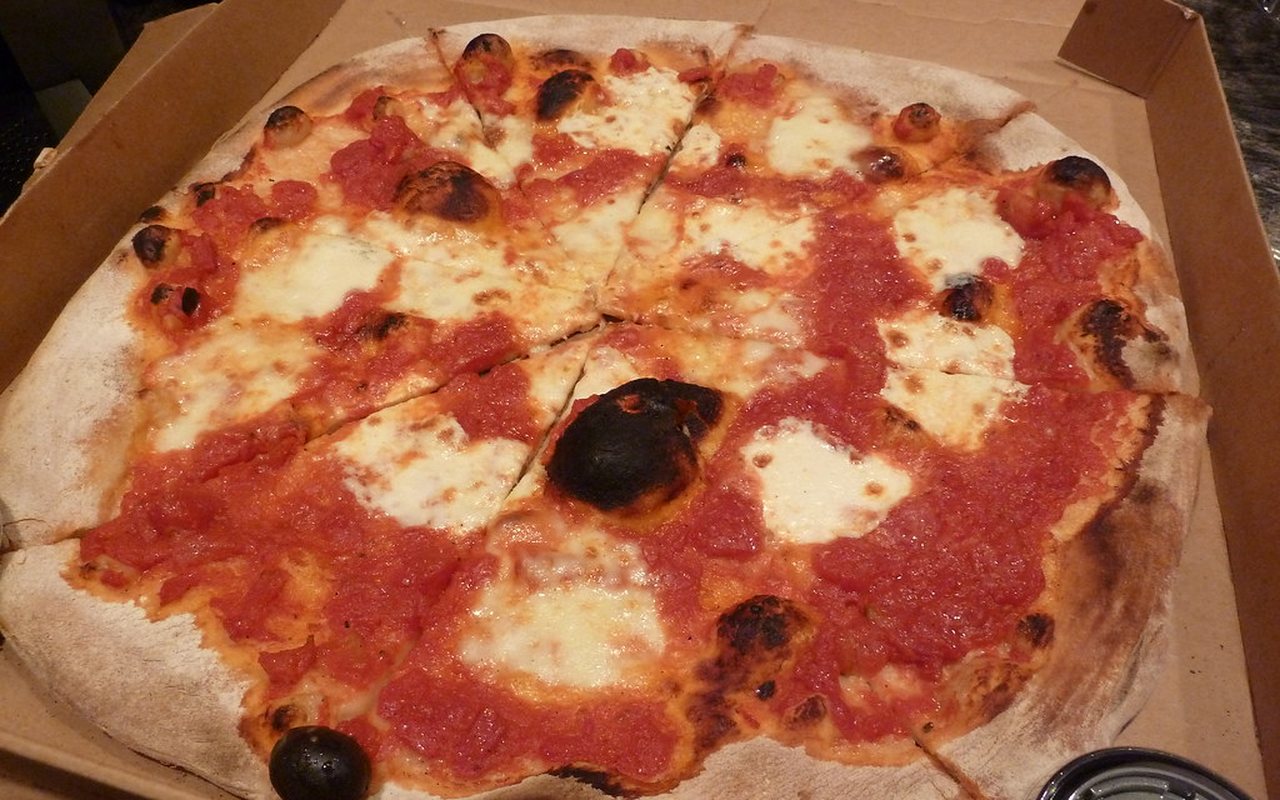 Small round oat-bran pizza topped with tomato sauce and melted cheese