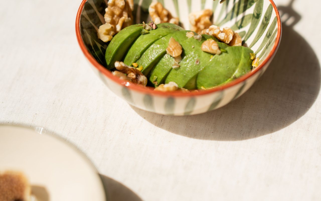 Creamy avocado and walnut salad served in avocado shells