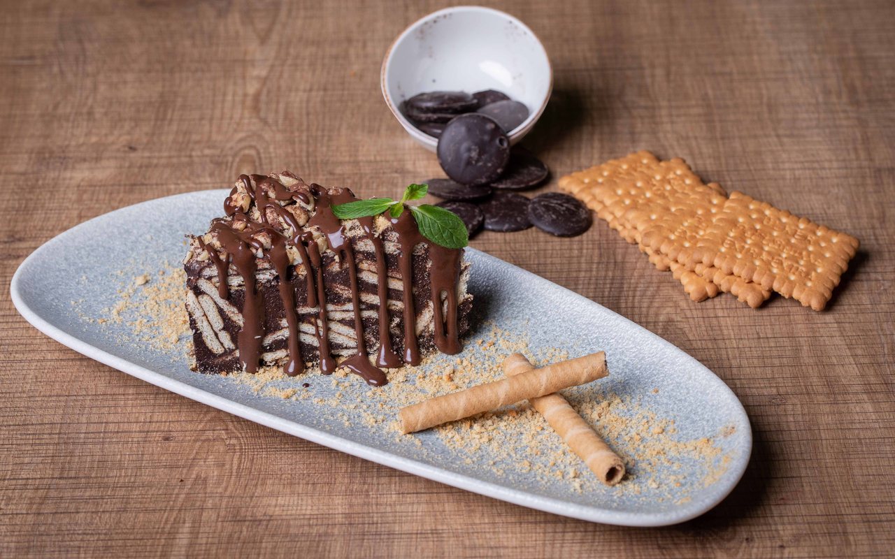 Slices of no-bake chocolate mosaic cake with visible biscuit pieces