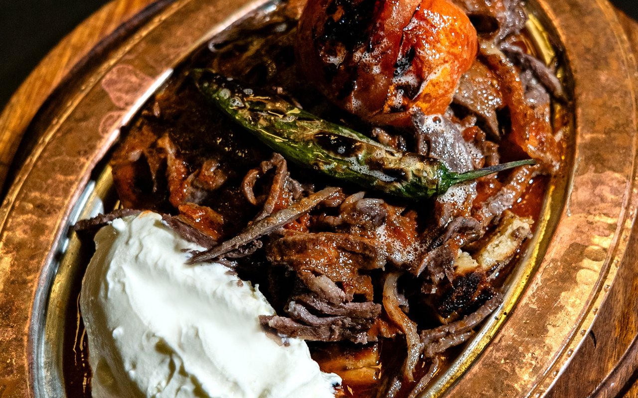 Thin seared beef slices covered with buttery tomato sauce