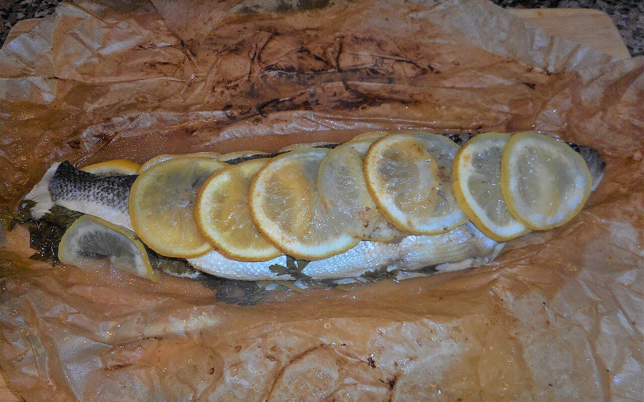 Thin slices of citrus-marinated sea bass with onion and herbs