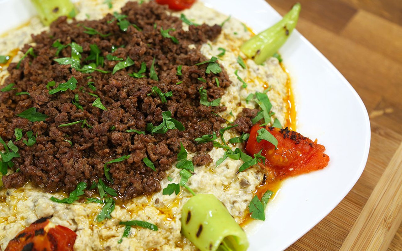 Ali Nazik with seasoned ground meat over eggplant-yogurt puree, parsley, grilled tomato, and peppers