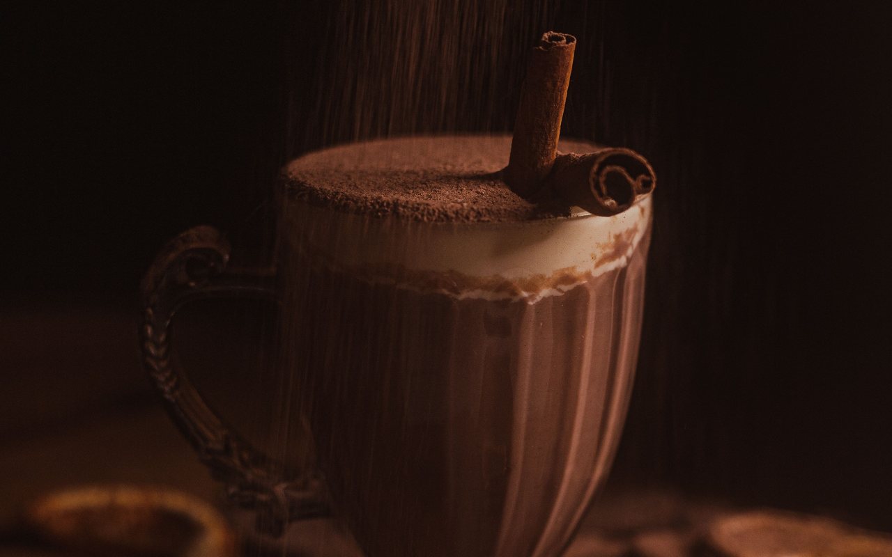 One mug of dark hot chocolate dusted with cinnamon and red pepper