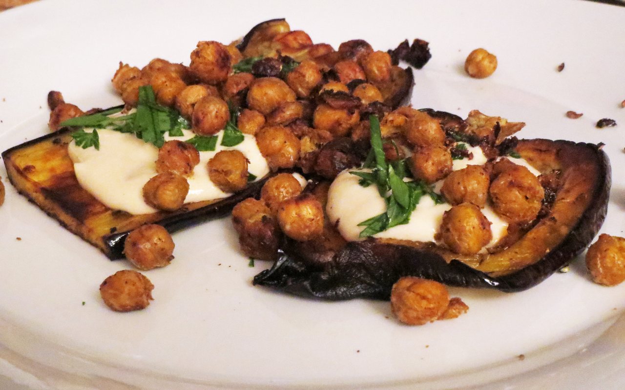 Roasted eggplant with yogurt-tahini sauce, crisped chickpeas, cumin, and parsley
