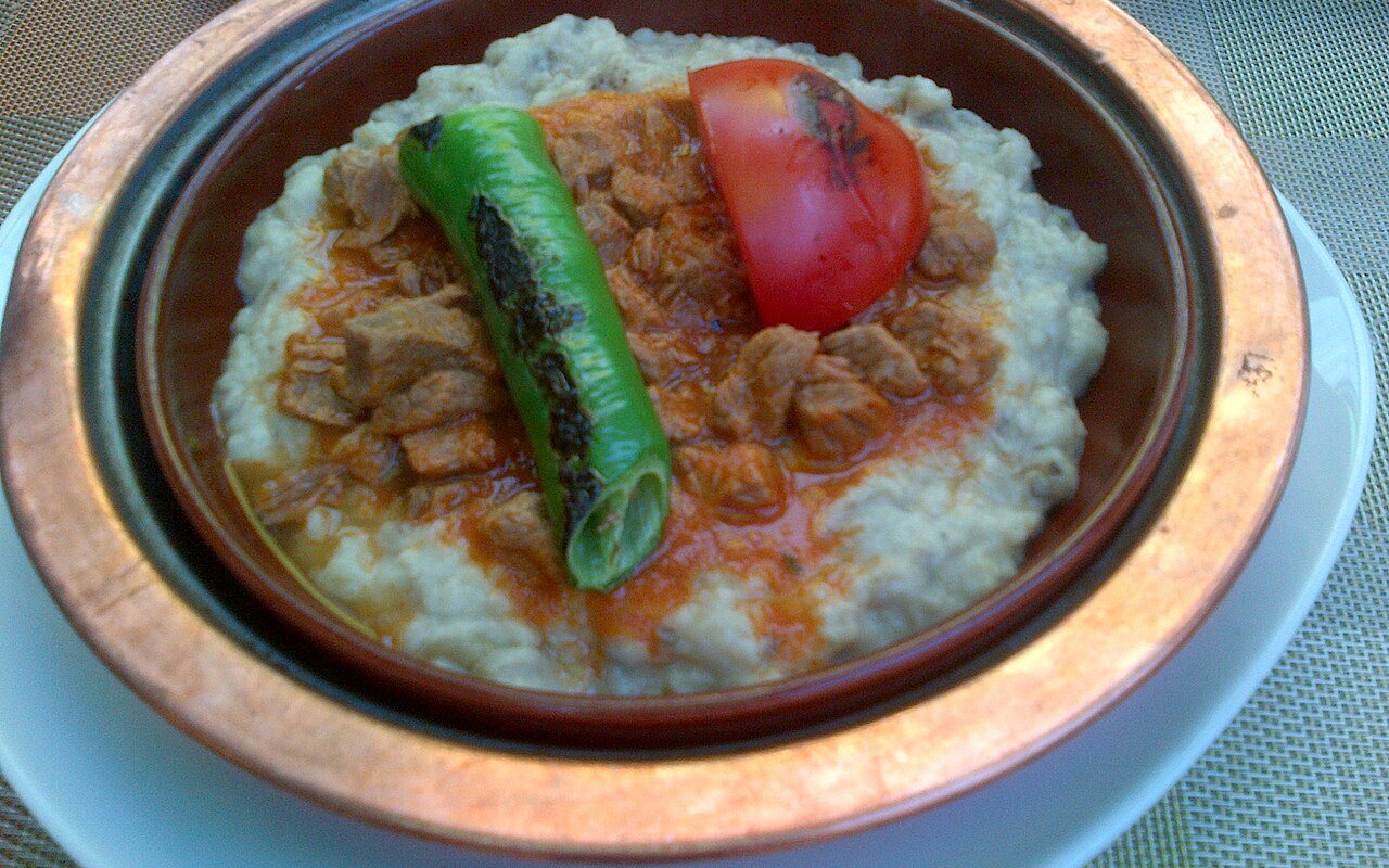 Braised beef in tomato sauce served over creamy roasted eggplant purée