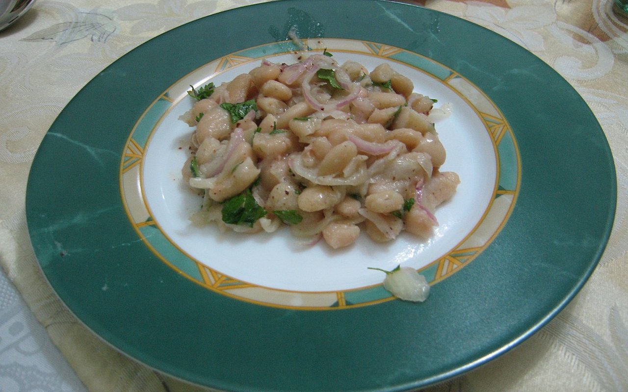 White bean piyaz salad with red onion, parsley, and sliced hard-boiled egg