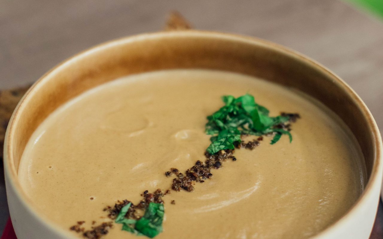 Smooth caramelized onion soup in a serving bowl