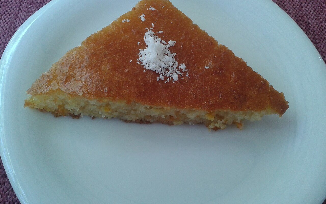 Diamond slices of golden revani topped with shredded coconut