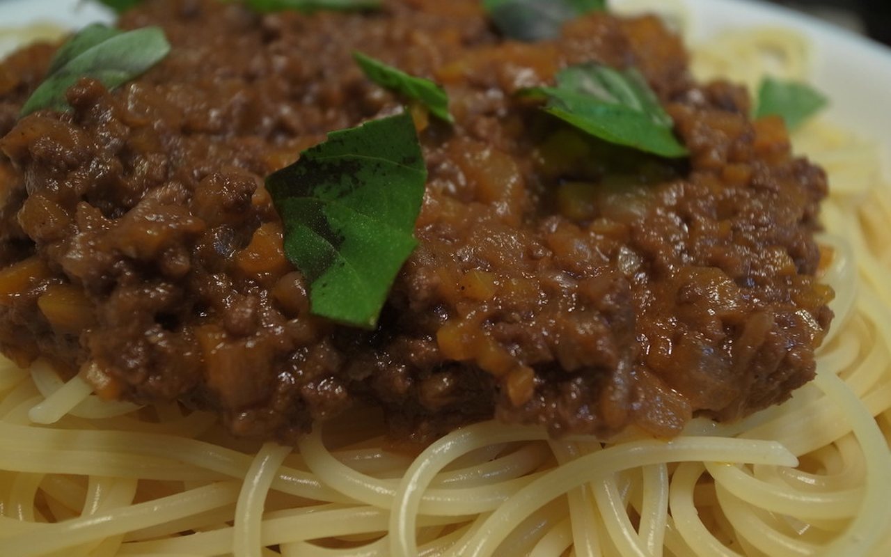 Plate of spaghetti topped with ground-meat tomato Bolognese sauce