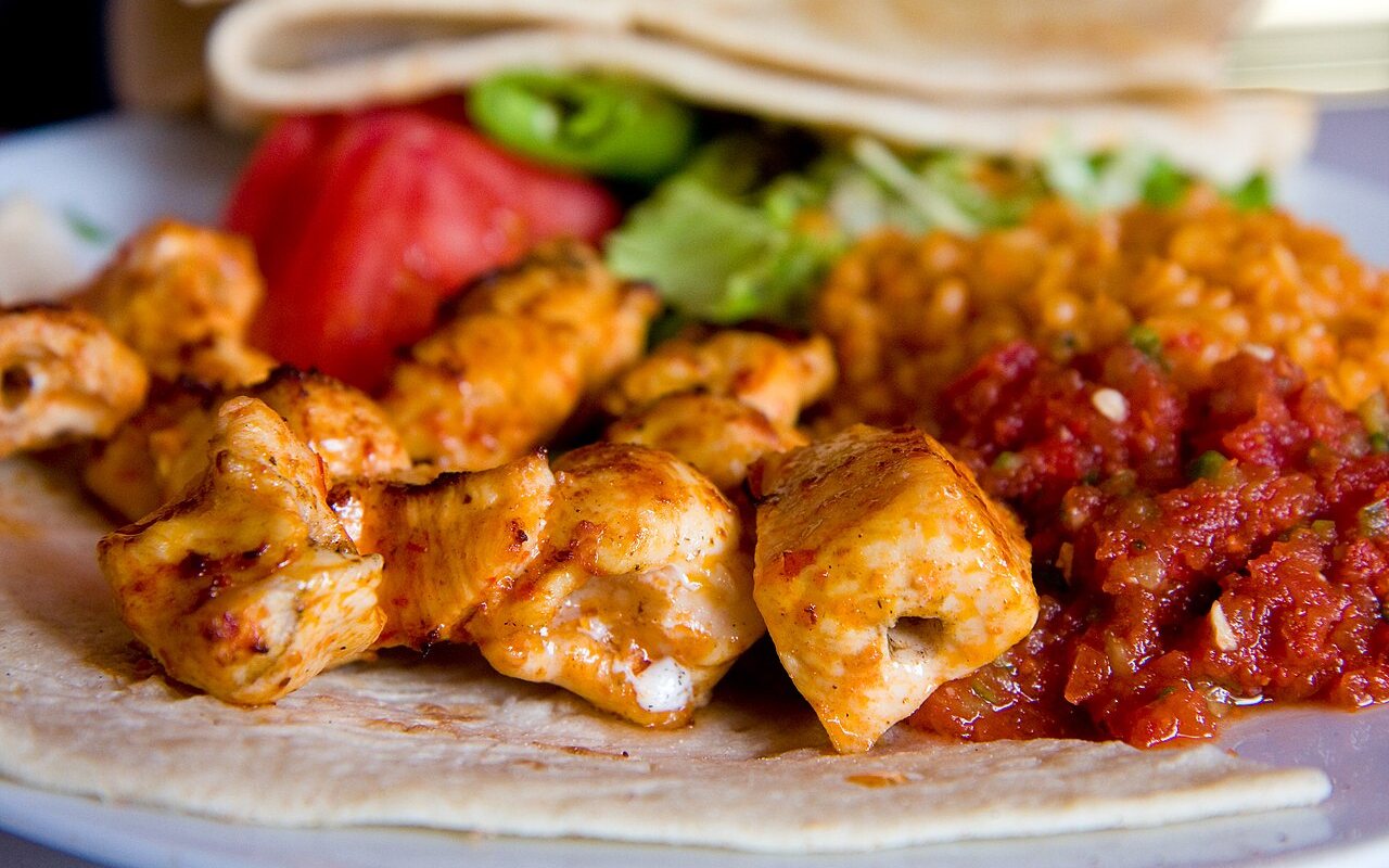 Grilled chicken, onion, and pepper pieces threaded on skewers