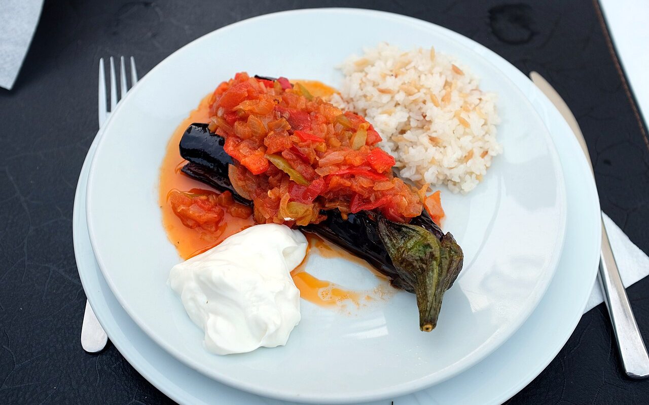 Whole eggplants split and filled with a tomato, onion, pepper, and potato mixture