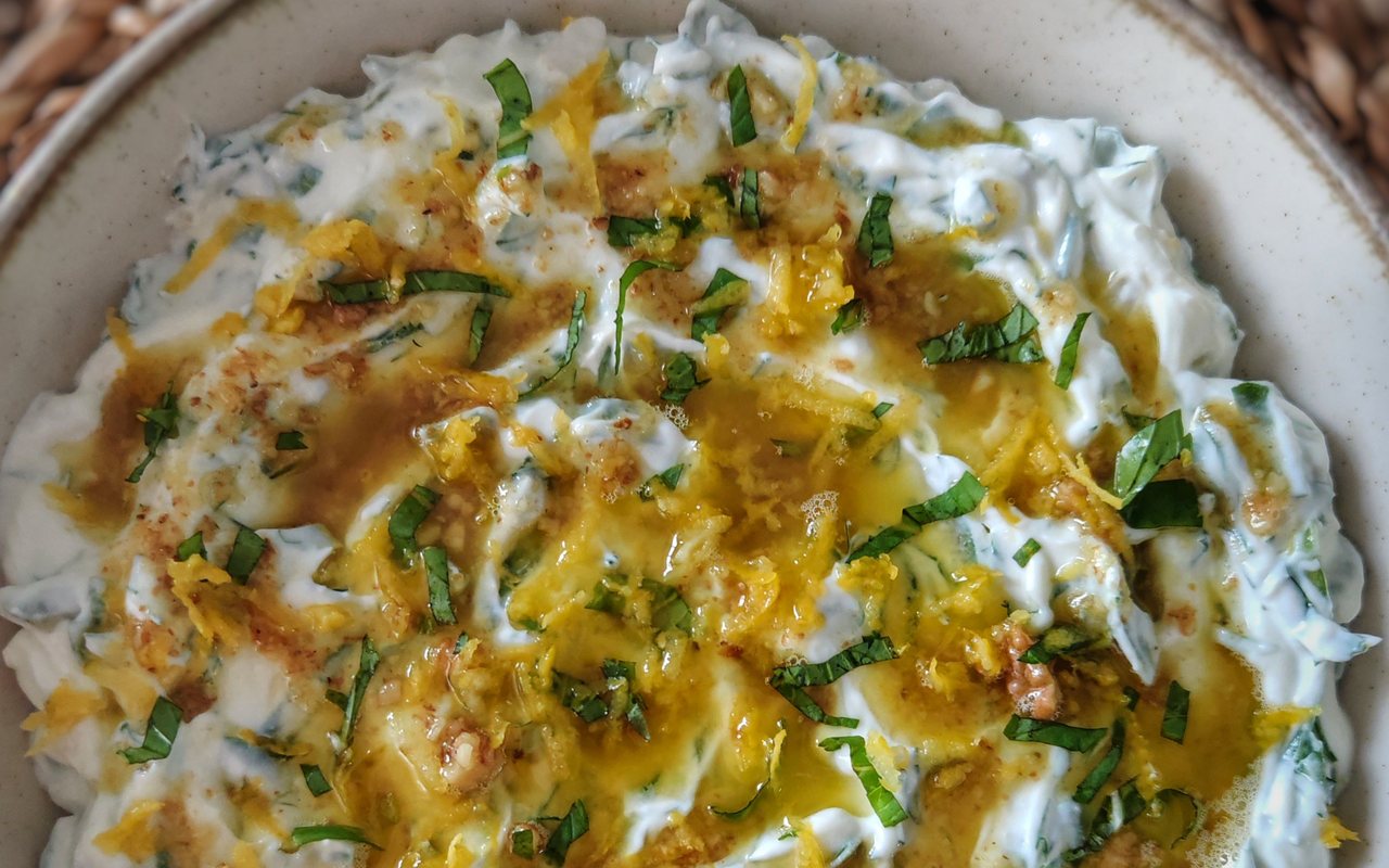 Haydari yogurt dip garnished with dill, mint, and walnuts