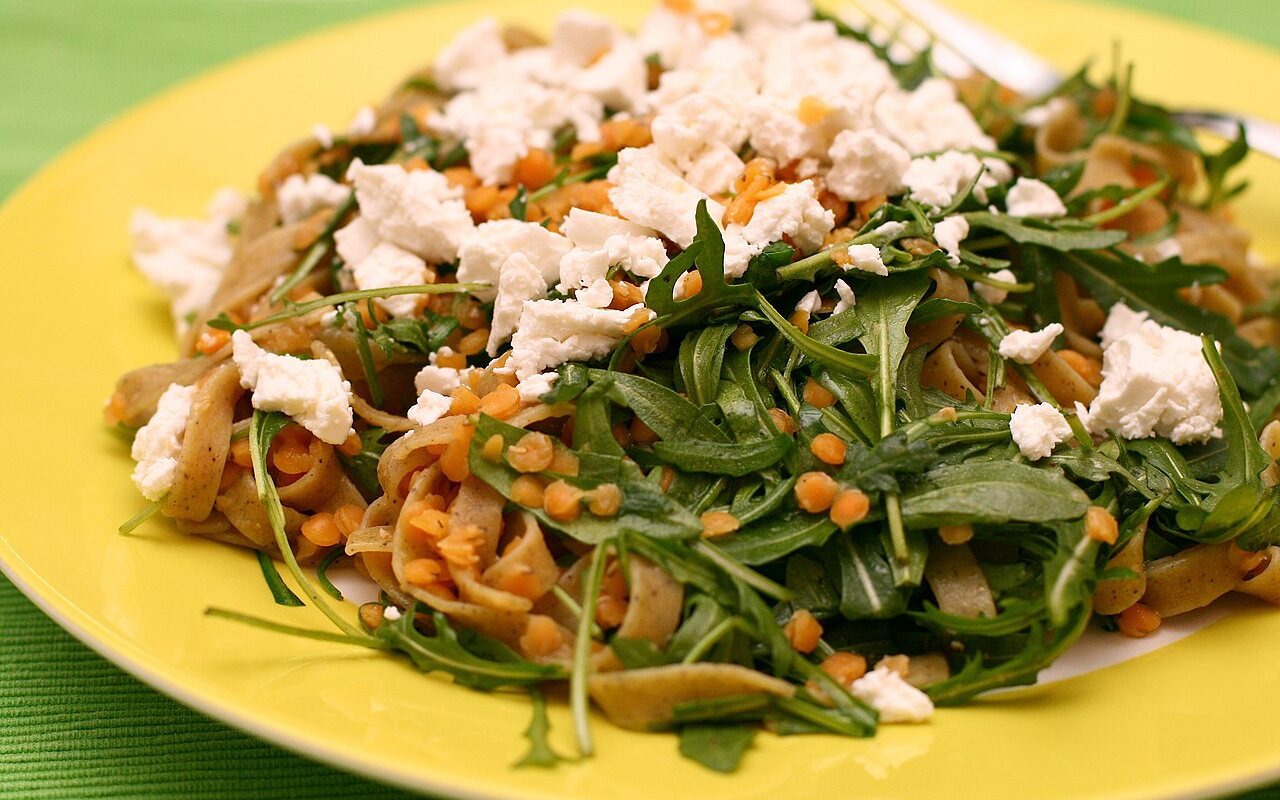 Whole-wheat pasta with red lentils, arugula, and goat cheese
