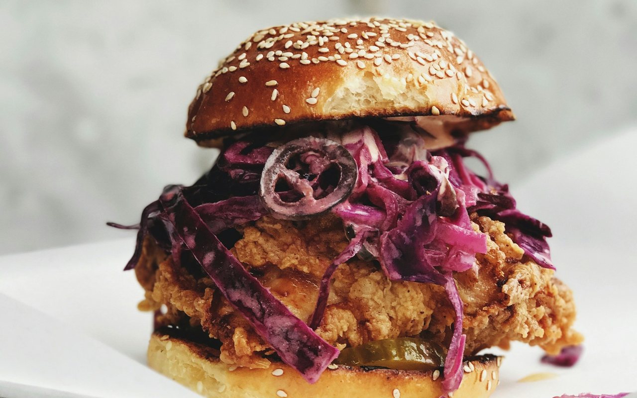 Crispy chicken burger on a bun with creamy shredded lettuce