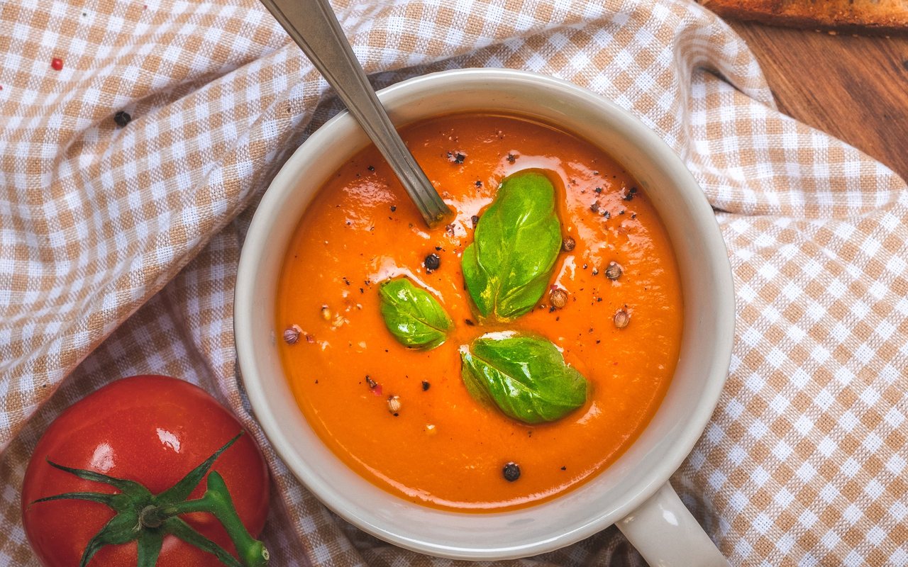 Smooth tomato soup topped with grated cheese