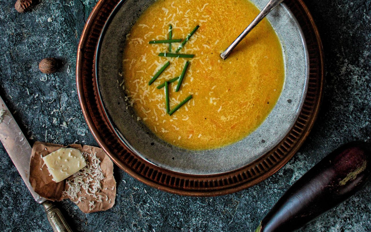 Creamy roasted eggplant soup topped with dried mint butter