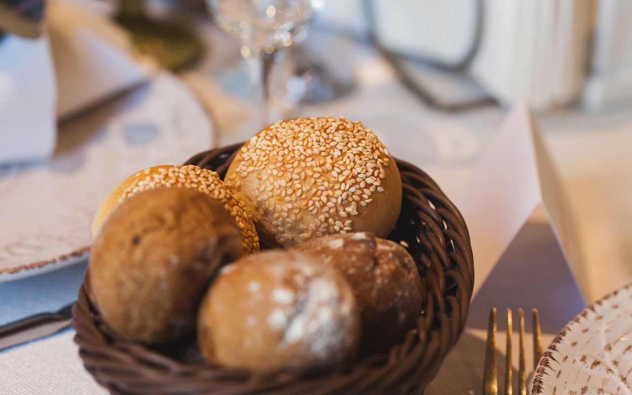 Ten round whole wheat rolls browned on a baking tray