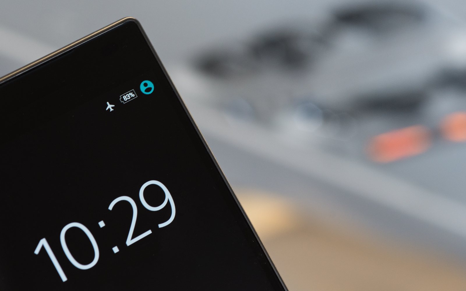 Close-up of a smartphone lock screen showing the time and status icons.
