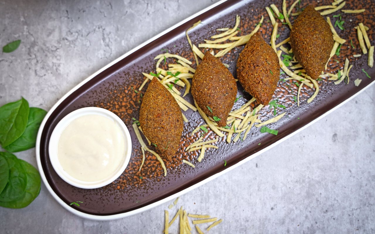 Golden falafel with a bowl of yogurt-tahini sauce