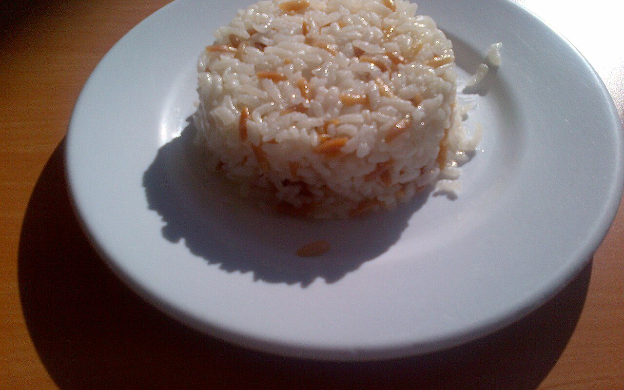 Fluffy white rice pilaf dotted with toasted golden orzo