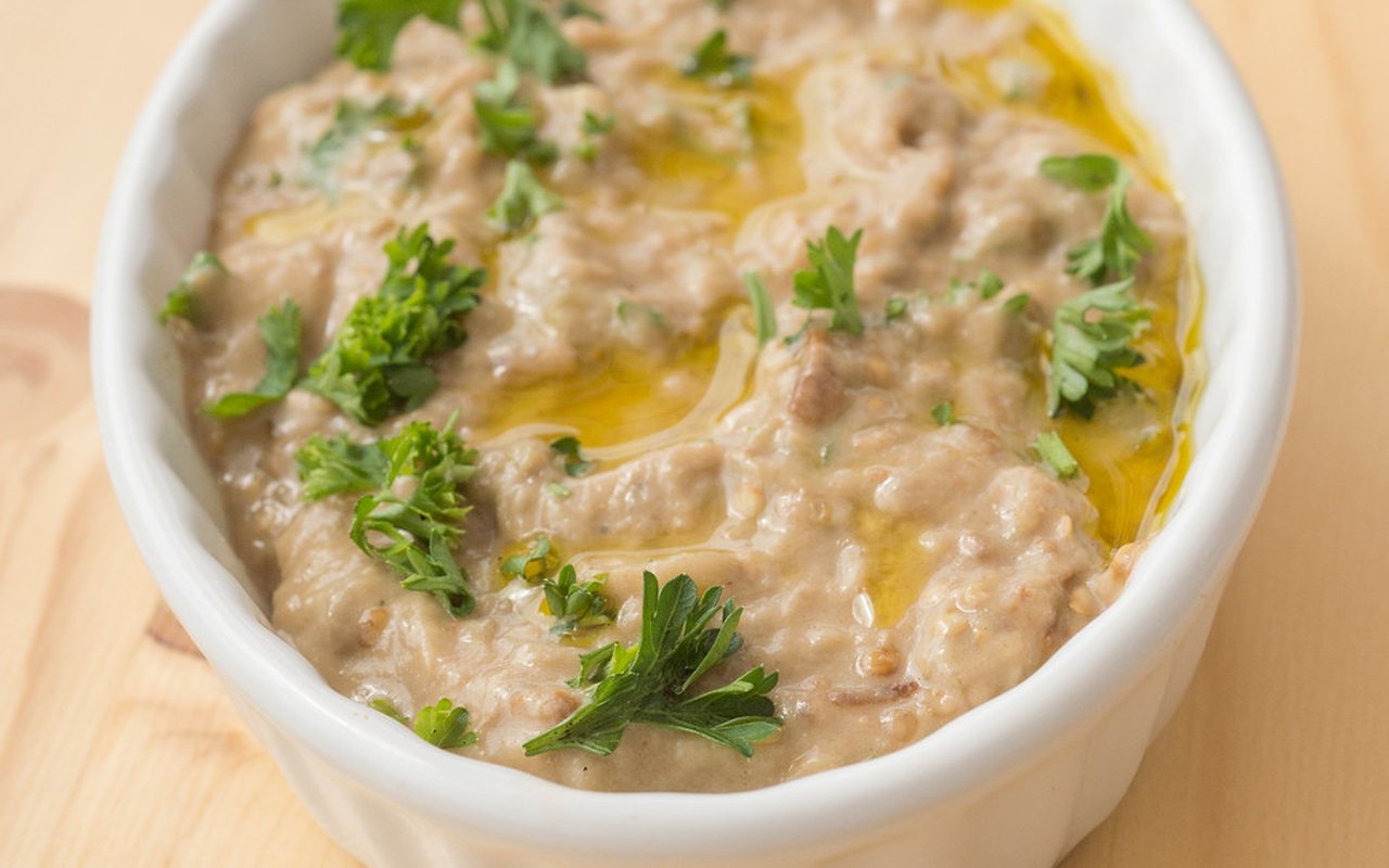 Creamy roasted eggplant dip topped with walnuts and red pepper butter