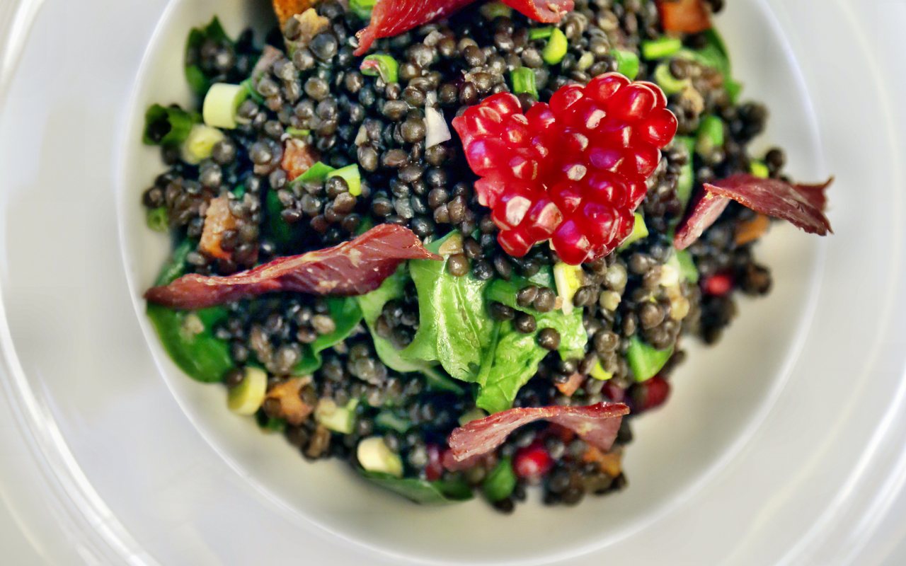 Black lentil and leafy green salad with pomegranate arils