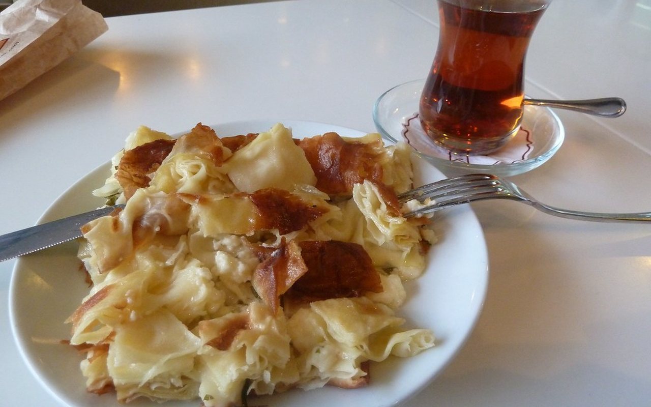Layered Turkish su böreği cut into squares on a tray