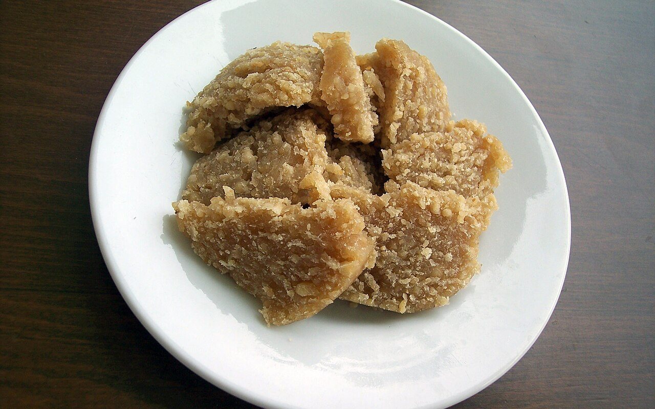 Scoops of golden-brown Turkish flour halva arranged on a serving plate