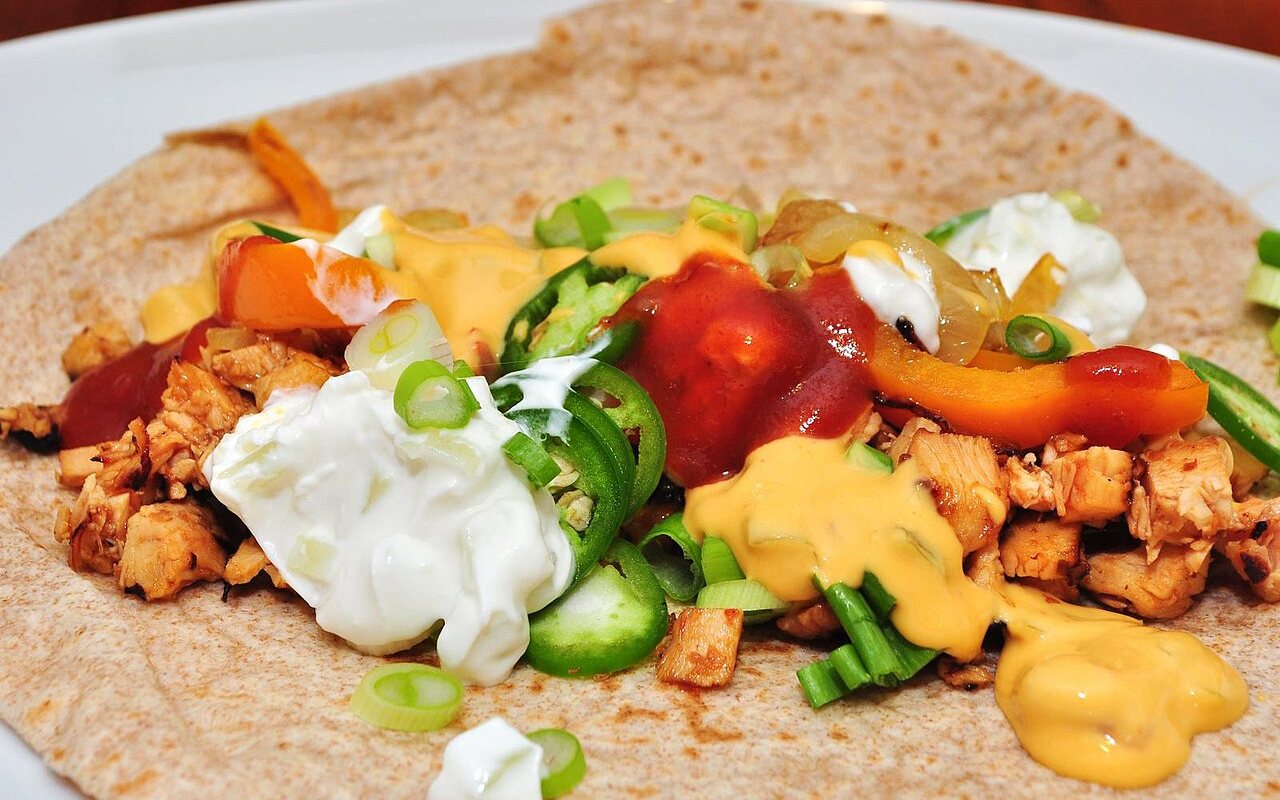 Chicken and sliced red and green peppers served in flour tortillas
