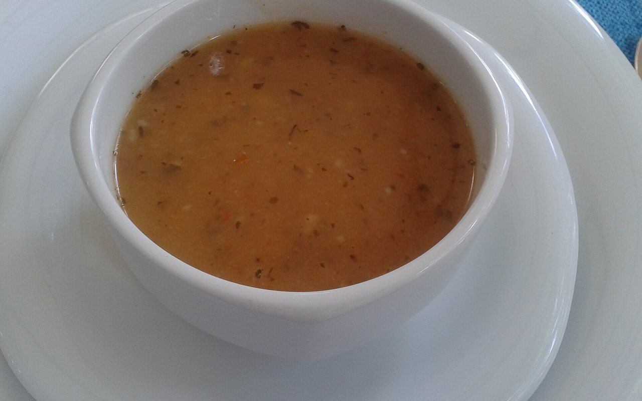 A bowl of smooth reddish Turkish tarhana soup