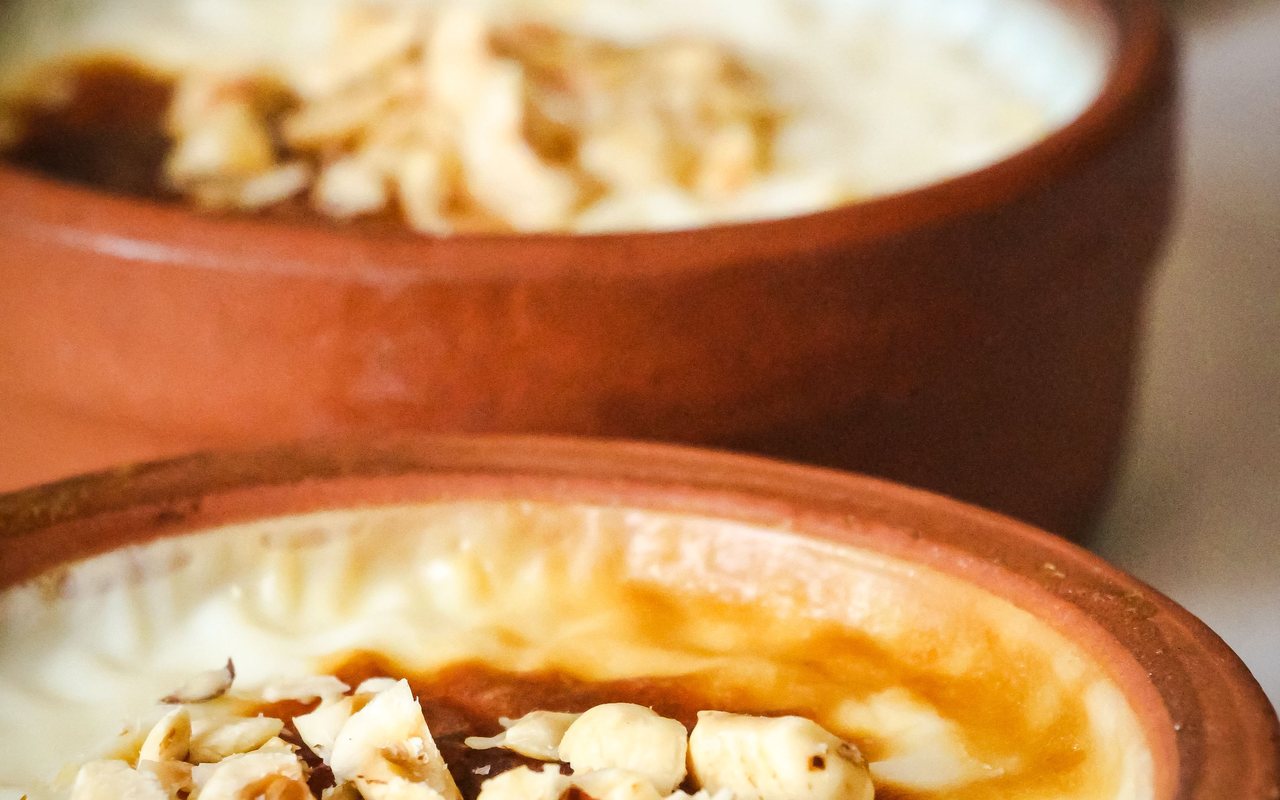 Individual dishes of creamy rice pudding with browned baked tops