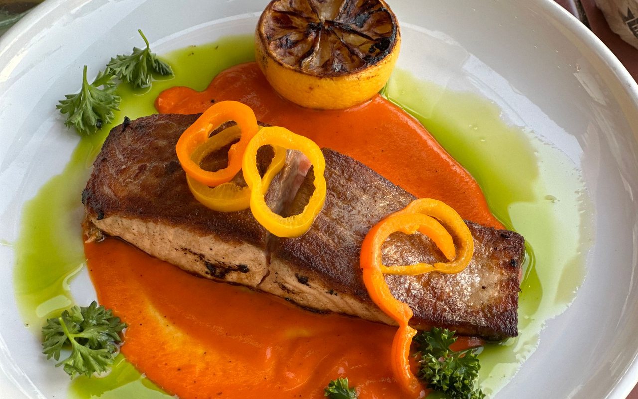 Pan-grilled salmon fillets seasoned with orange, peppercorns, and thyme