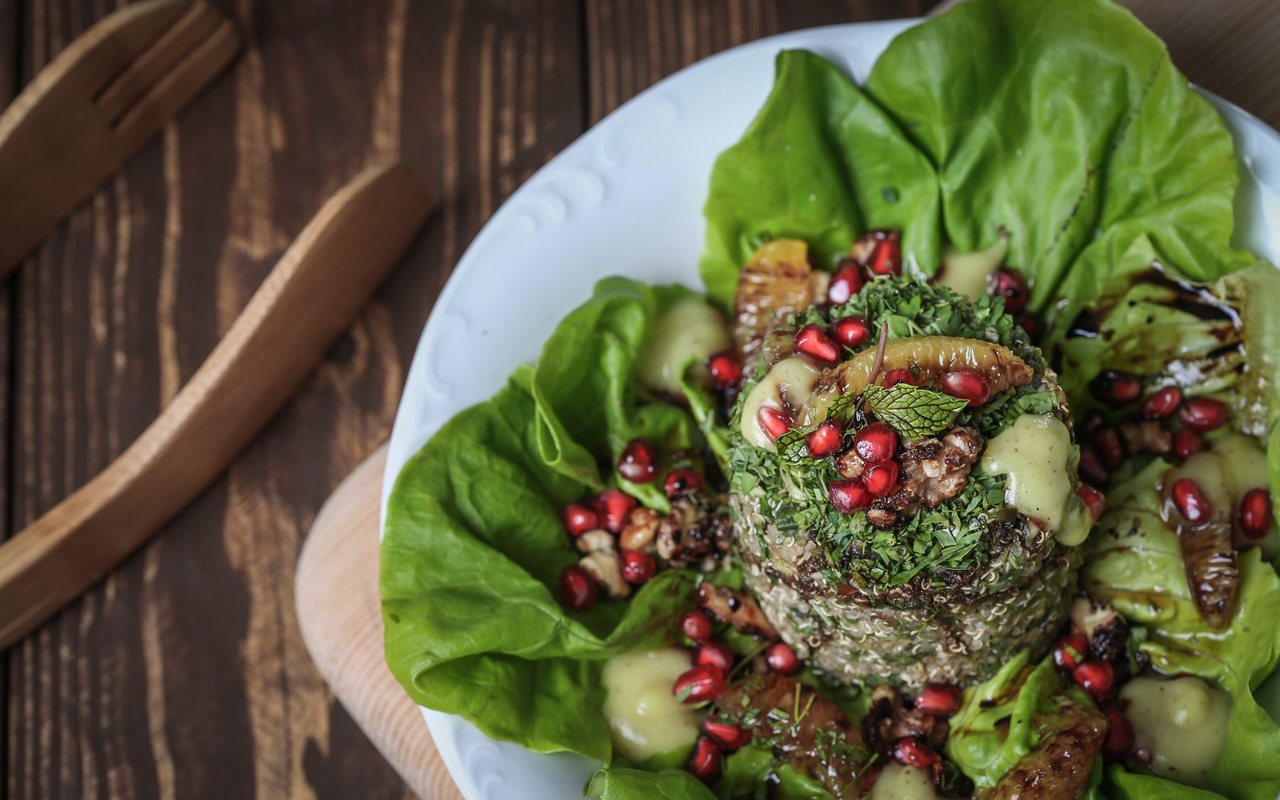 Quinoa salad with chopped parsley, tomato, and cucumber