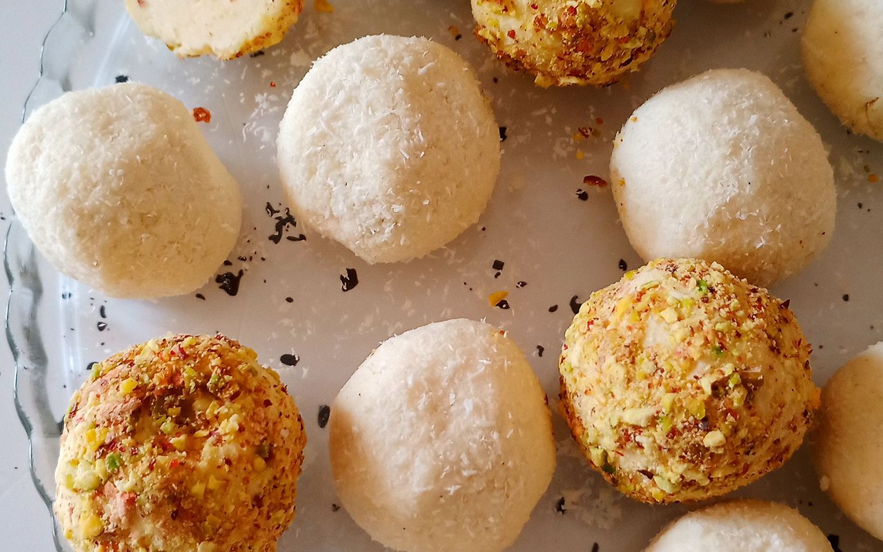 Small coconut-coated milk pudding bites topped with nuts