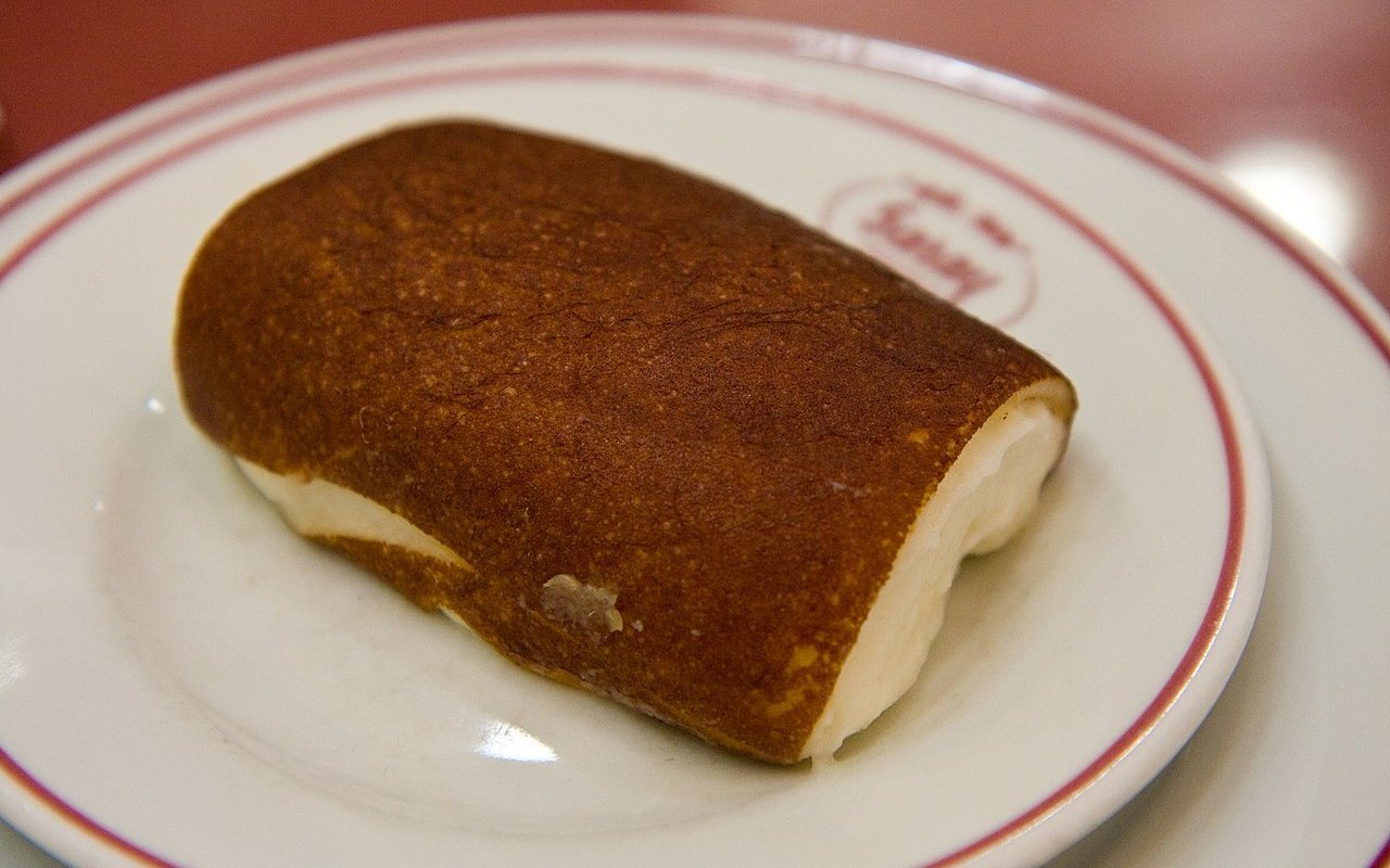 Rolled slices of kazandibi showing a dark caramelized surface
