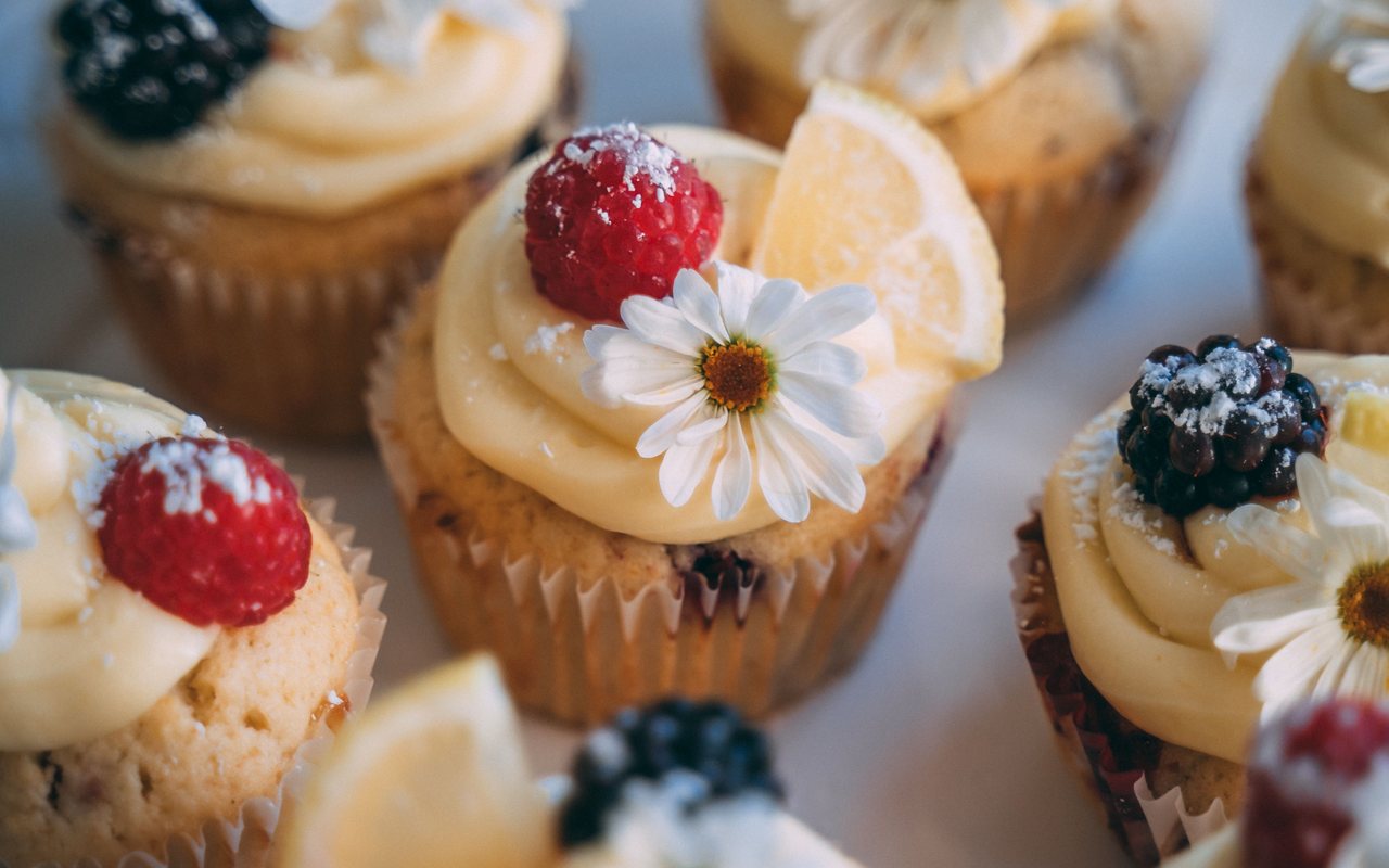 Lemon cupcakes piped with frosting and filled with white chocolate