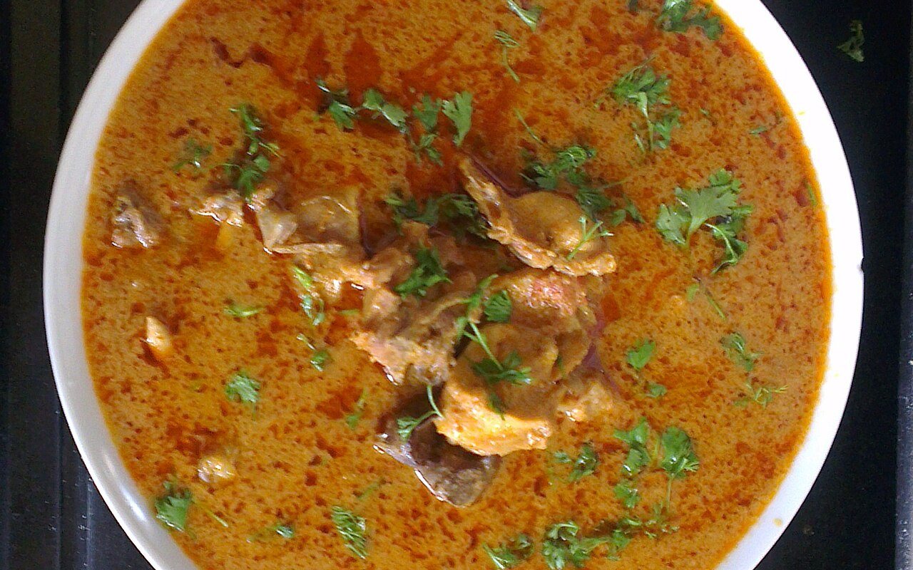 Chicken pieces coated in a creamy yellow curry sauce