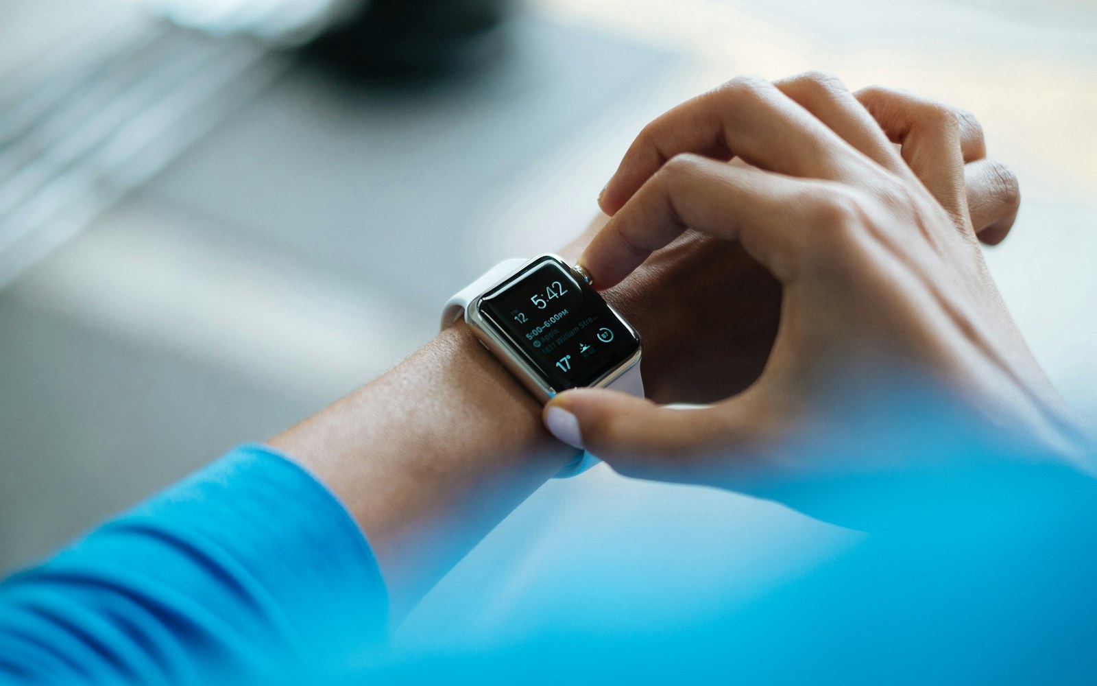 Person adjusts a smartwatch on their wrist