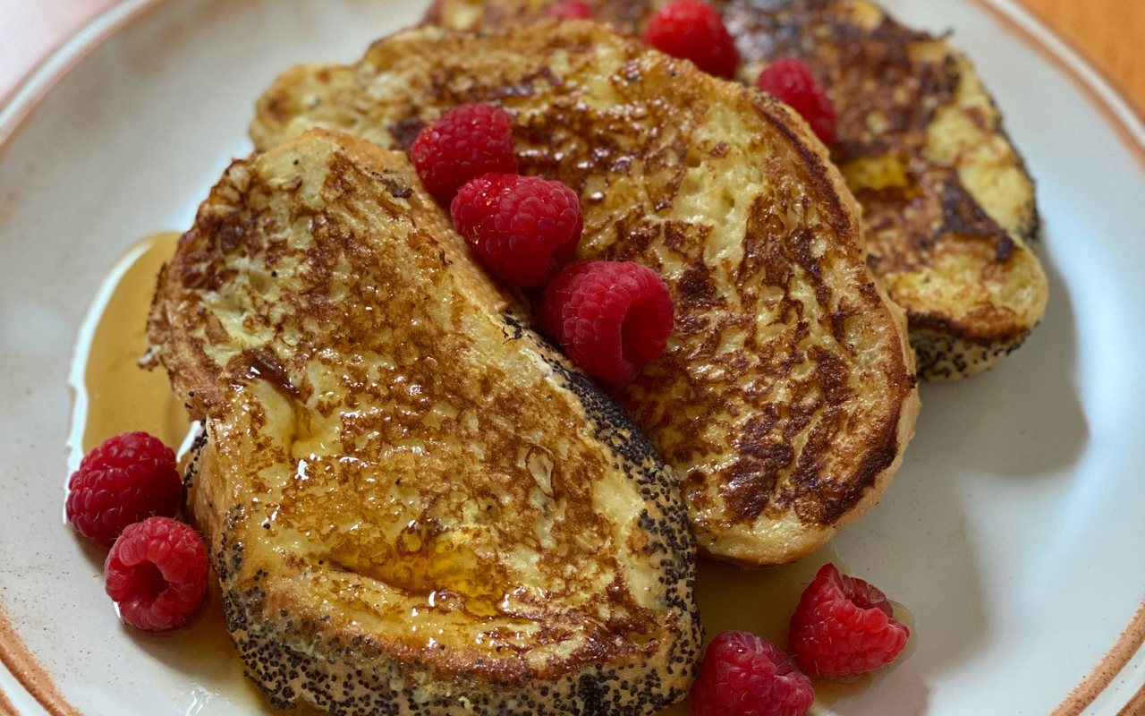 Golden slices of French toast stacked on a serving plate
