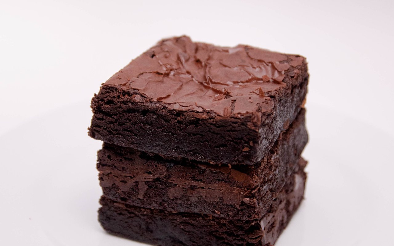 Square dark chocolate brownies cut into ten pieces